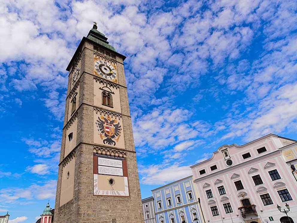 medevial city tower of Enns, with with clock, sun clock, city arms