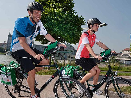 a couple is enjoying the ride on their bikes on Danube Cycle Path