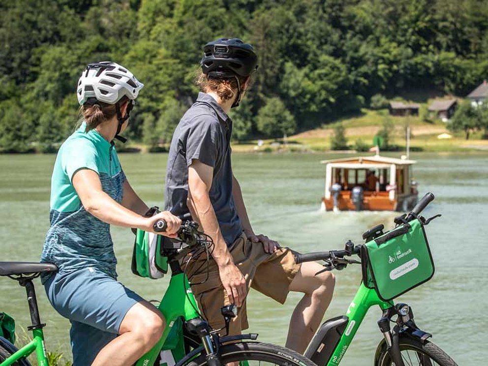 couple watch the Danube ferry in the cycling holidays in Austria