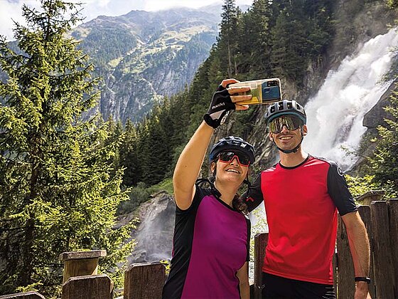 2 Personen machen ein Selfie vor dem Krimmler Wasserfall