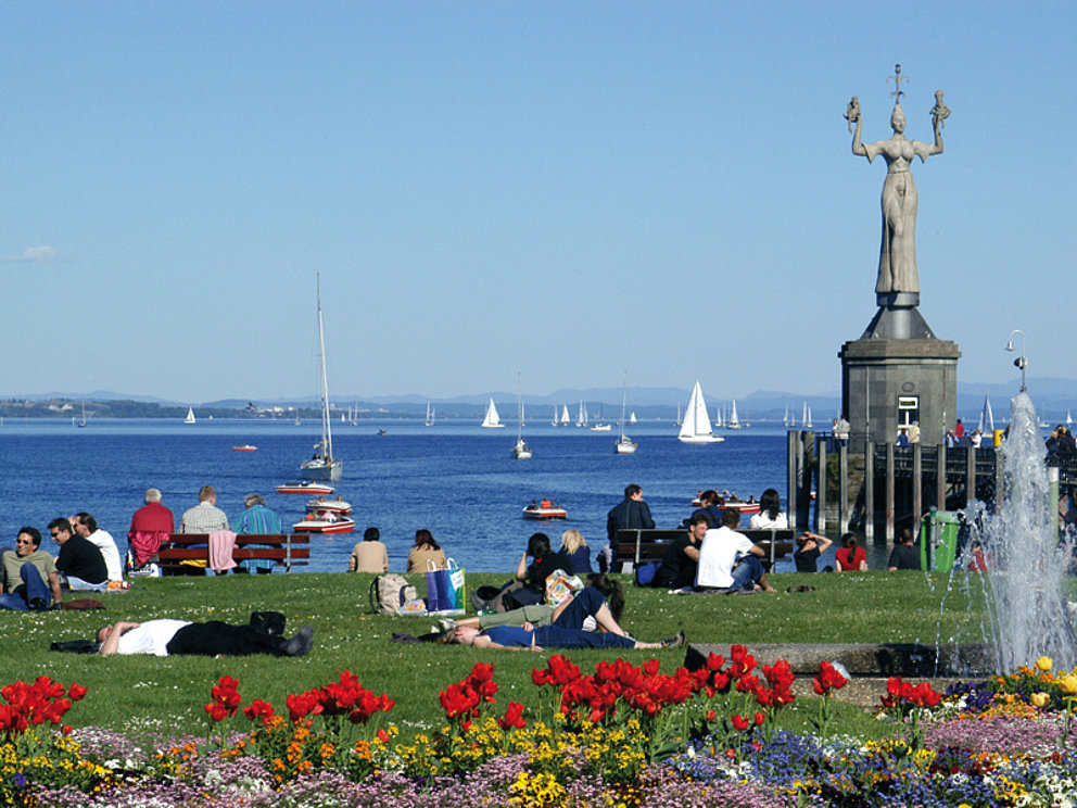 people are spending leisure time at the promenade of Konstanz, Lake Constance