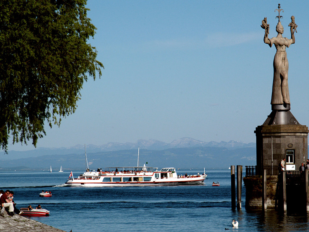 statue Imperia at Konstanz watching an excursion boat on the Lake